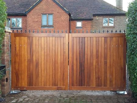 Steel finials to the top of a solid timber gate for security